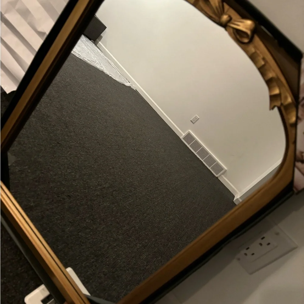 Gold bow mirror size is 18 x 24